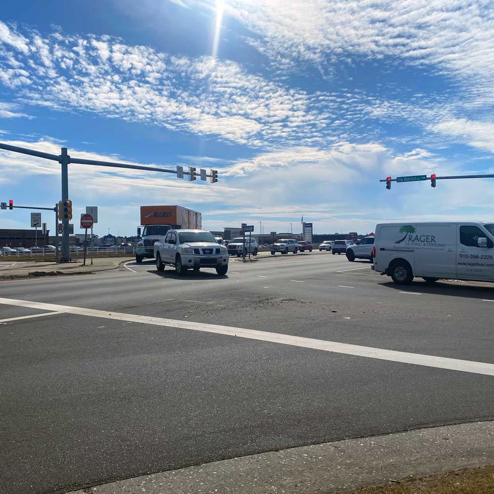 A busy intersection on US 17 in Leland, NC, showing multiple vehicles and traffic signals.